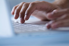 Closeup of hands typing on laptop