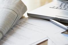 Newspaper pen and laptop