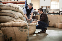 men inspecting coffee beans