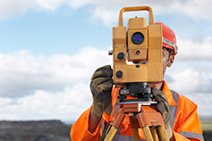 Worker at a mining site looking through lens