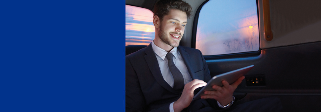 Man in car holding tablet