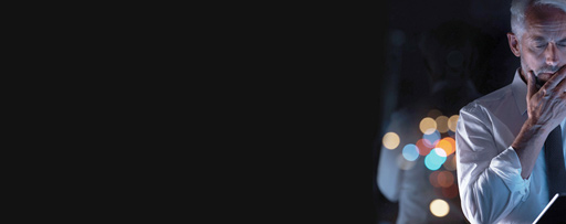 man with hand on face looking at tablet