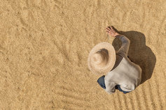 Overhead view of a farmer sifting through wheat