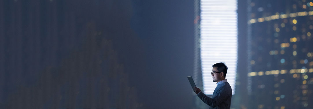 Smart businessman using tablet in city