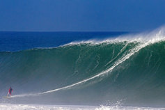 Man surfing with a huge tide