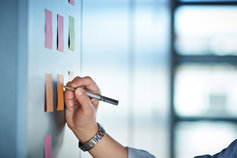 writing on sticky notes on wall