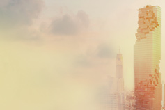 modern skyscraper besides clouds