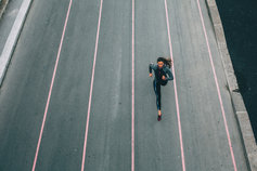 Woman running on track