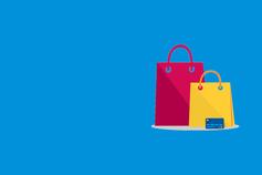 Revenue | Woman in a yellow dress carrying colourful shopping bags ,