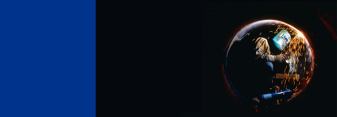 Man drilling under circle fire flames black background