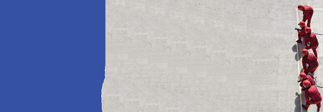 People wearing red working on road