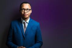 Man wearing blue suit facing camera