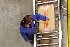 Top view of woman packaging boxes