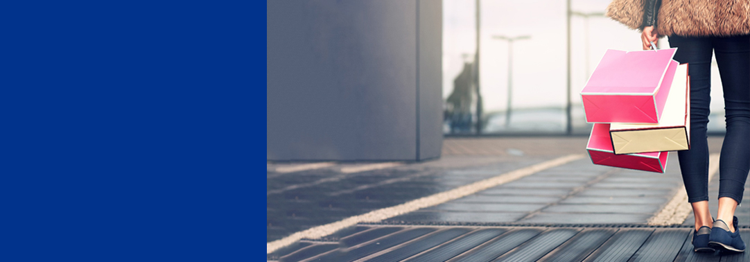 woman walking away with shopping bags