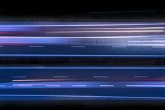 Laser light roads in the dark lines across black background