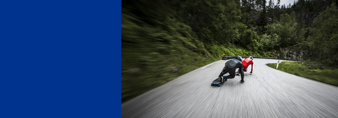 Skaters in red and black on long skateboard