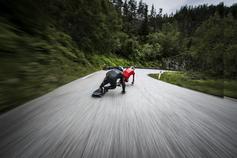 Skaters in Red and black on long skate board