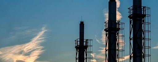 Three construction pillars with blue sky white and yellow clouds in the background