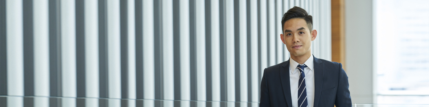Man wearing formal suit with blue tie