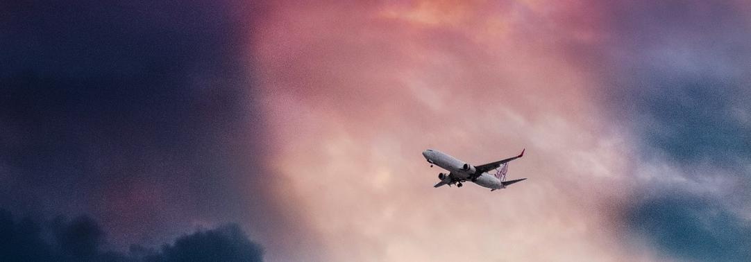 Airplane flying at dawn