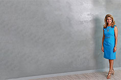 Woman standing wearing blue dress