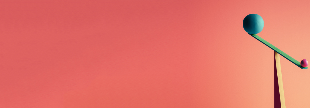 Two spherical balls of different sizes on balancing wooden plank or see saw