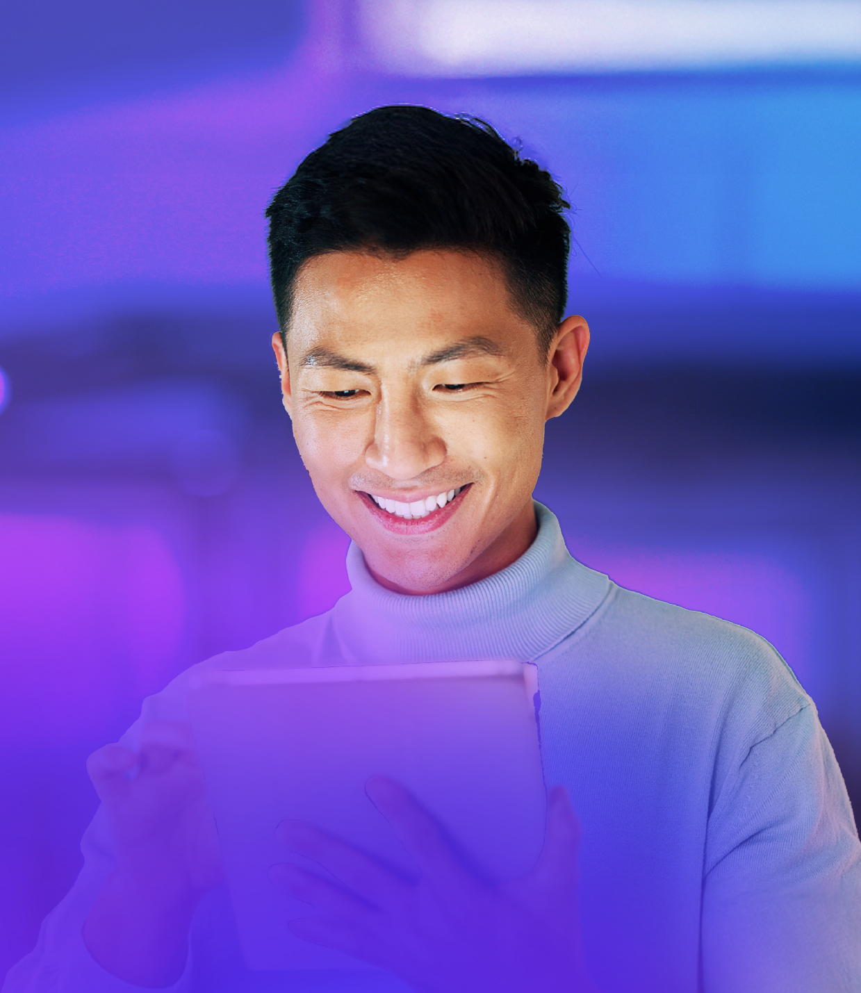 Man smiling while looking at his phone