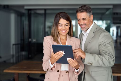 Woman and man looking at tablet