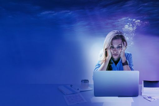 Person under water with computer
