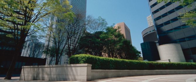 KPMG earnings per share handbook publication image: a city public square with tall buildings and trees