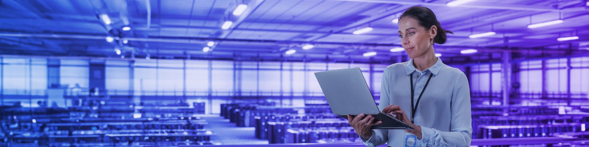 Woman working on laptop in data center