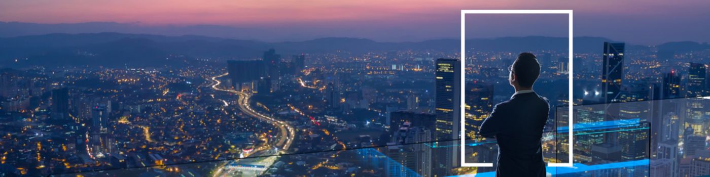 Businessman looking out from rooftop over city