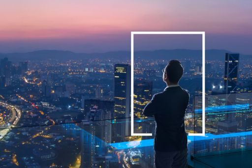 Businessman looking out from rooftop over city