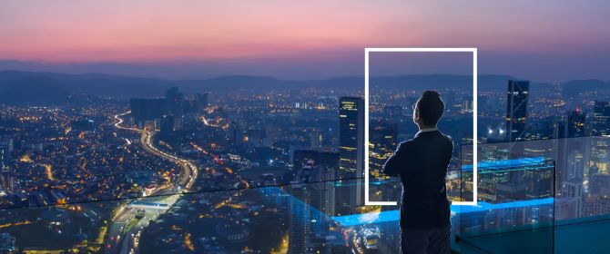 Businessman looking out from rooftop over city
