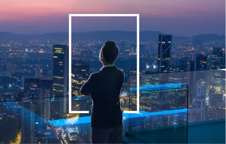 Businessman looking out from rooftop over city