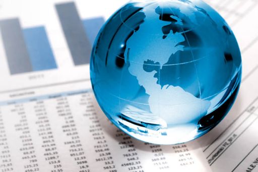 Glass globe on financial papers