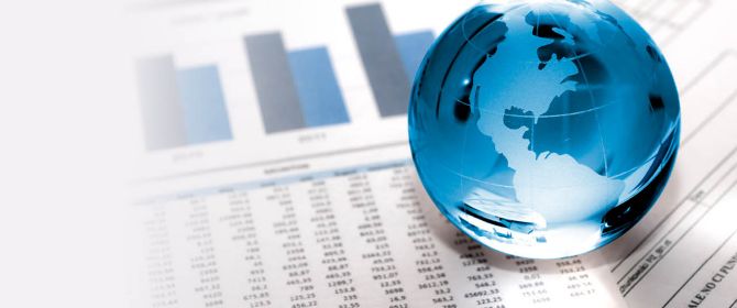 Glass globe on financial papers