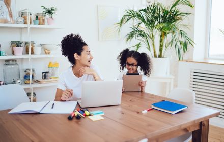 a-girl-smiling-while-working-on-laptop