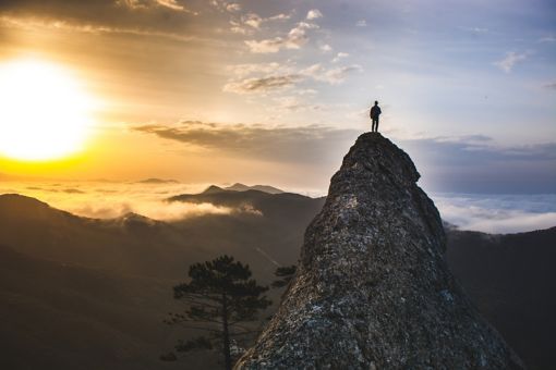 Man looking out from top of a mountain.