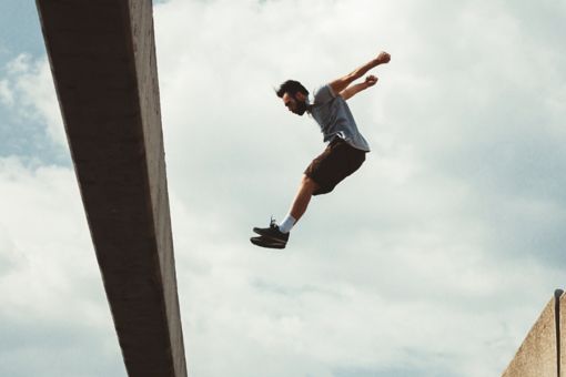 Man jumping over building