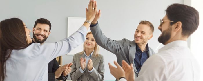 A group of people is giving a high five