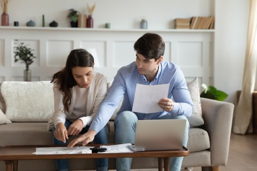 Two concentrated people looking at files