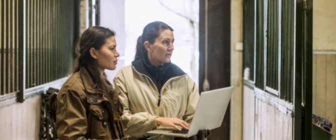two women working on a laptop