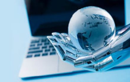 glass globe in robot hand in front of laptop