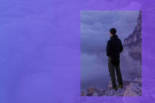 man looking over the cloud on top of a mountain
