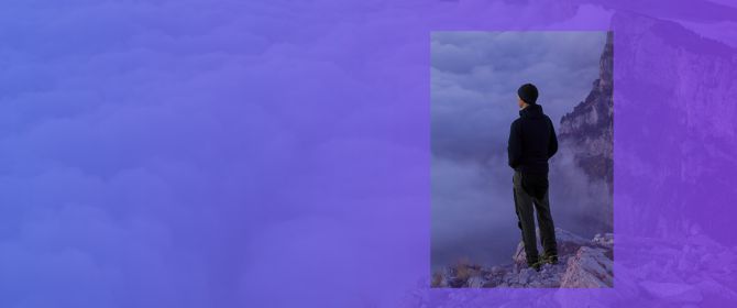 man looking over the cloud on top of a mountain