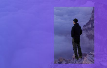 man looking over the cloud on top of a mountain