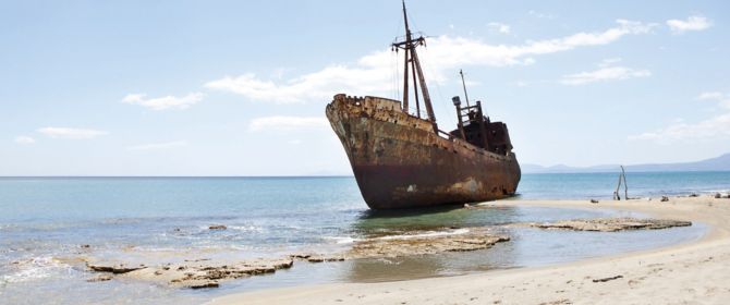 KPMG IFRS Newsletter: IFRS 9 Impairment publication image: rusting hull of a ship on a beach,KPMG IFRS Newsletter: Financial Instruments publication image: windsurfer jumping a wave
