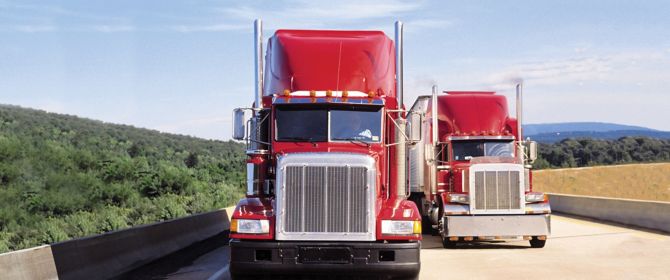 KPMG IFRS Newsletter: Leases publication image: two red trucks on a highway.