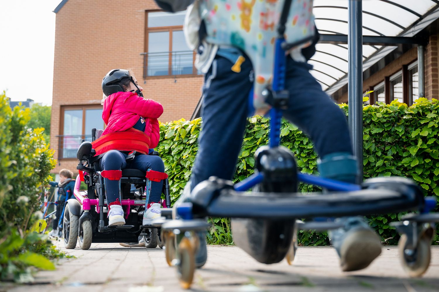 children in wheelchairs outside in the playground